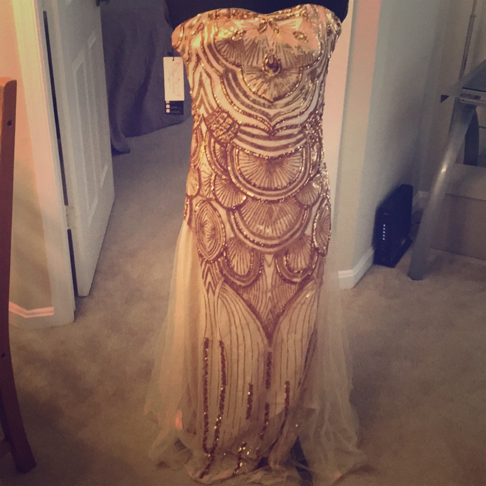 Sequence gown with open criss-cross back.